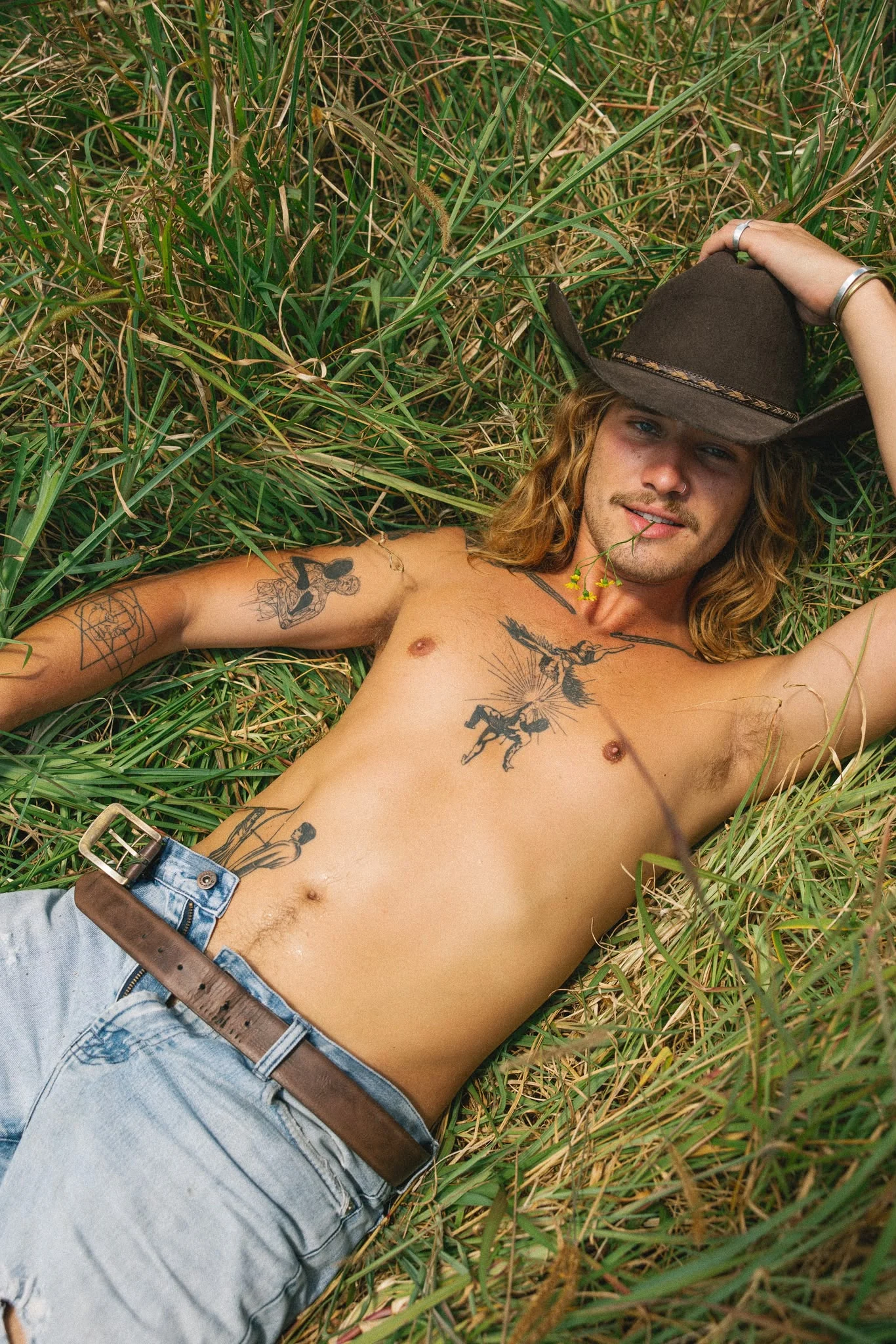 Cowboy lying in grass