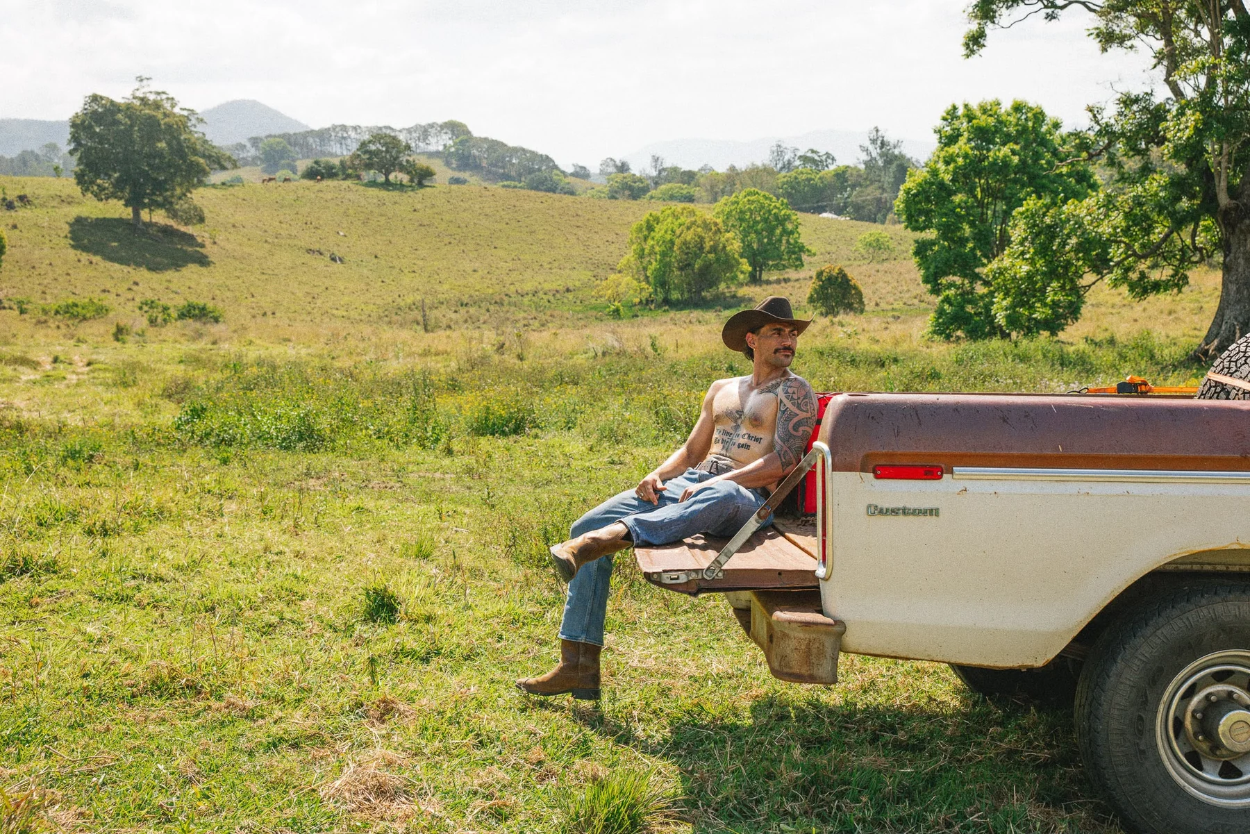 Cowboy sitting on a vintage ute